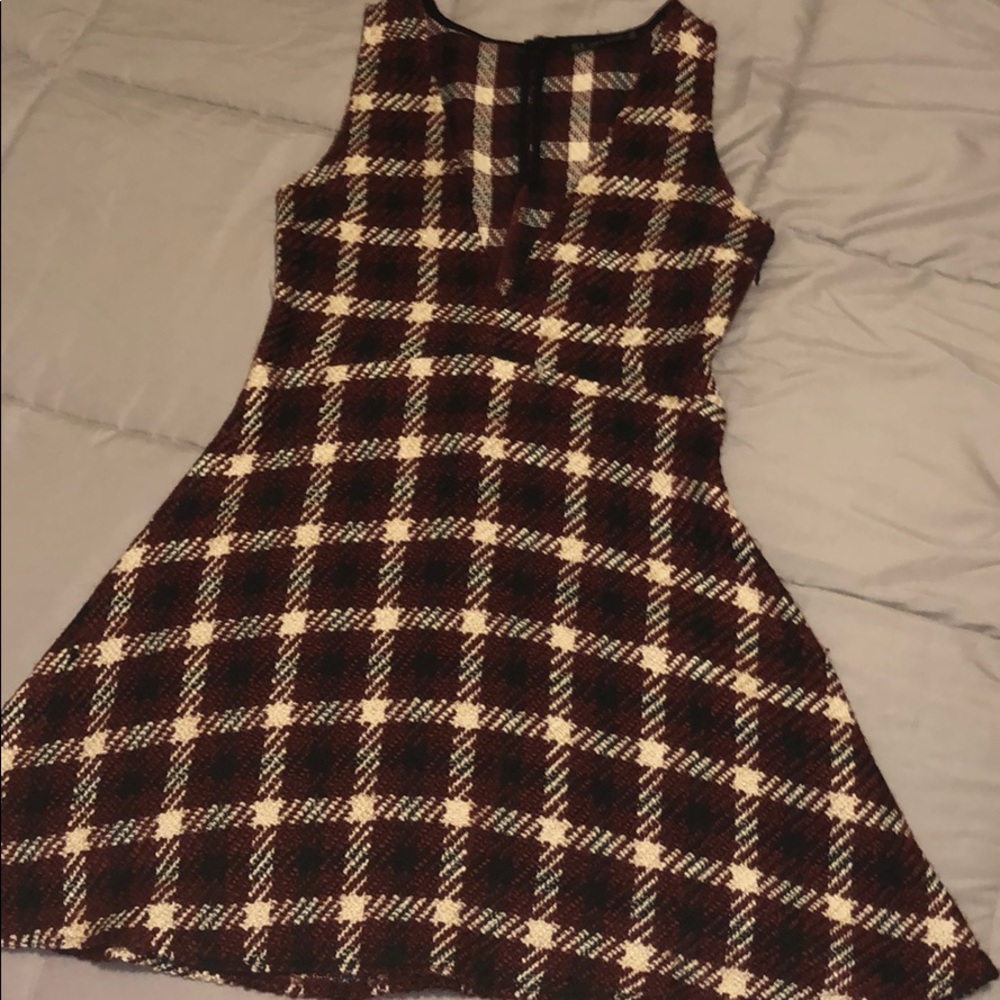 A burgundy, white, and black threaded dress.